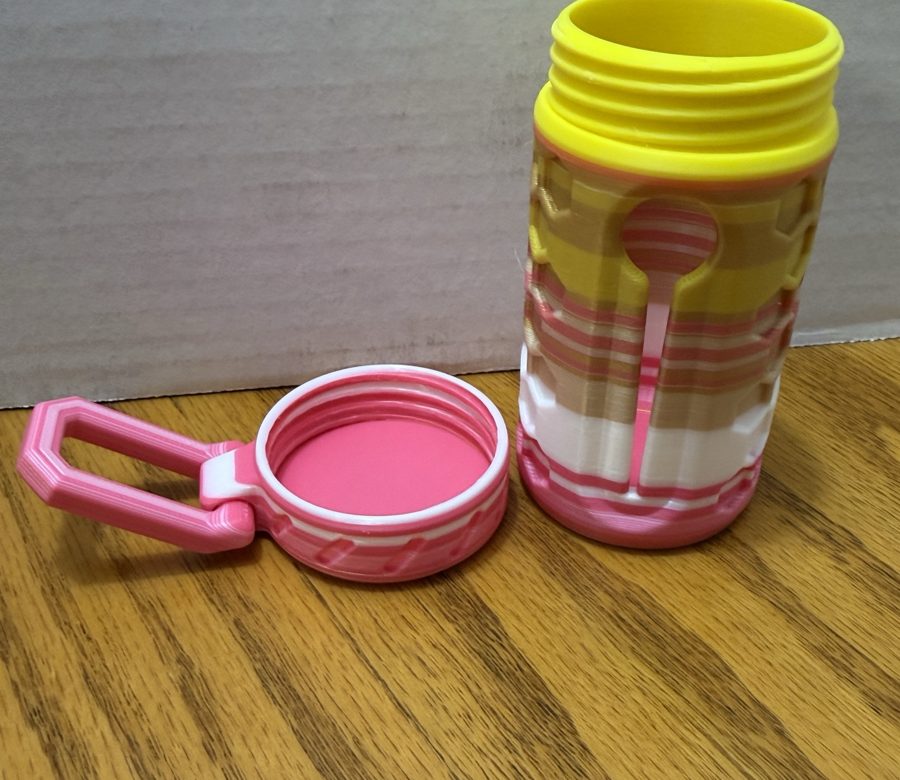 Pink and yellow poop bag holder with clip lid